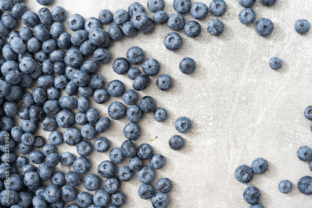 Raw Organic Blueberries on a gray background, side view. Copy space. Raw Organic Blueberries on a gray background, side view. Copy space.