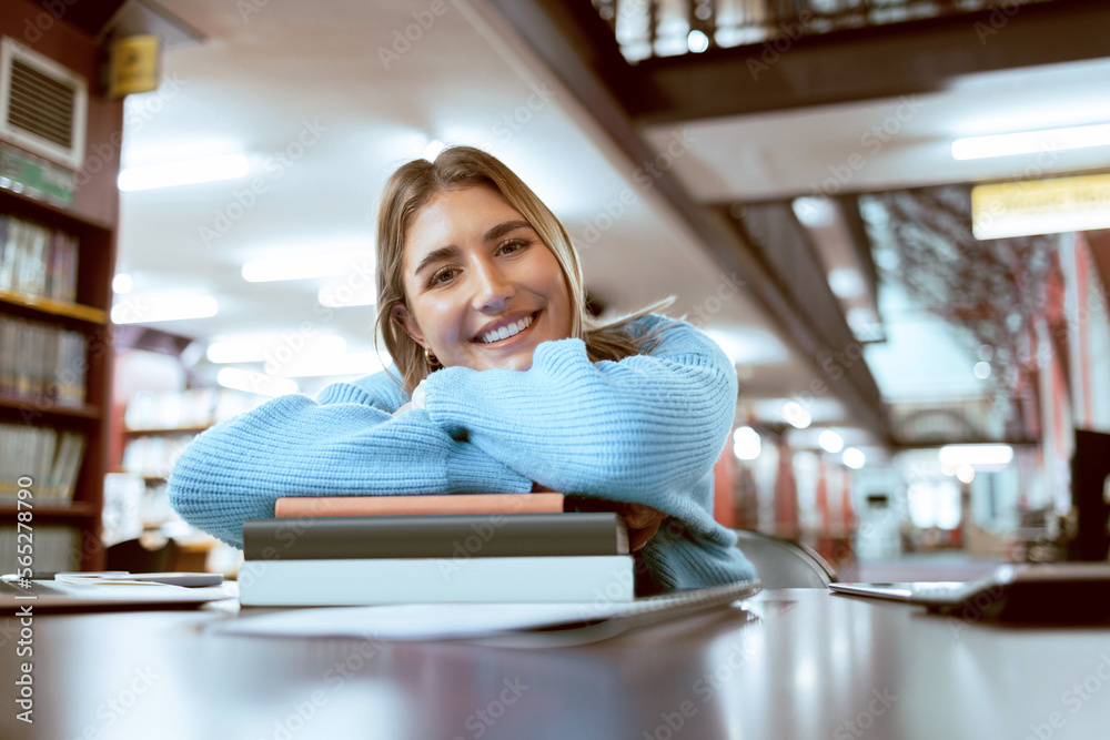 Portrait, woman and student in library, studying and higher education for knowledge, growth or learning. University, female academic or lady with books, smile or relax with scholarship or information - obrazy, fototapety, plakaty 