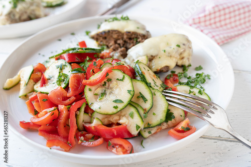 Zucchini salad with tomatoes and bell peppers marinated with olive oil, honey, vinegar and herbs