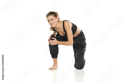 a young sporty woman with pain in her knee on a white background