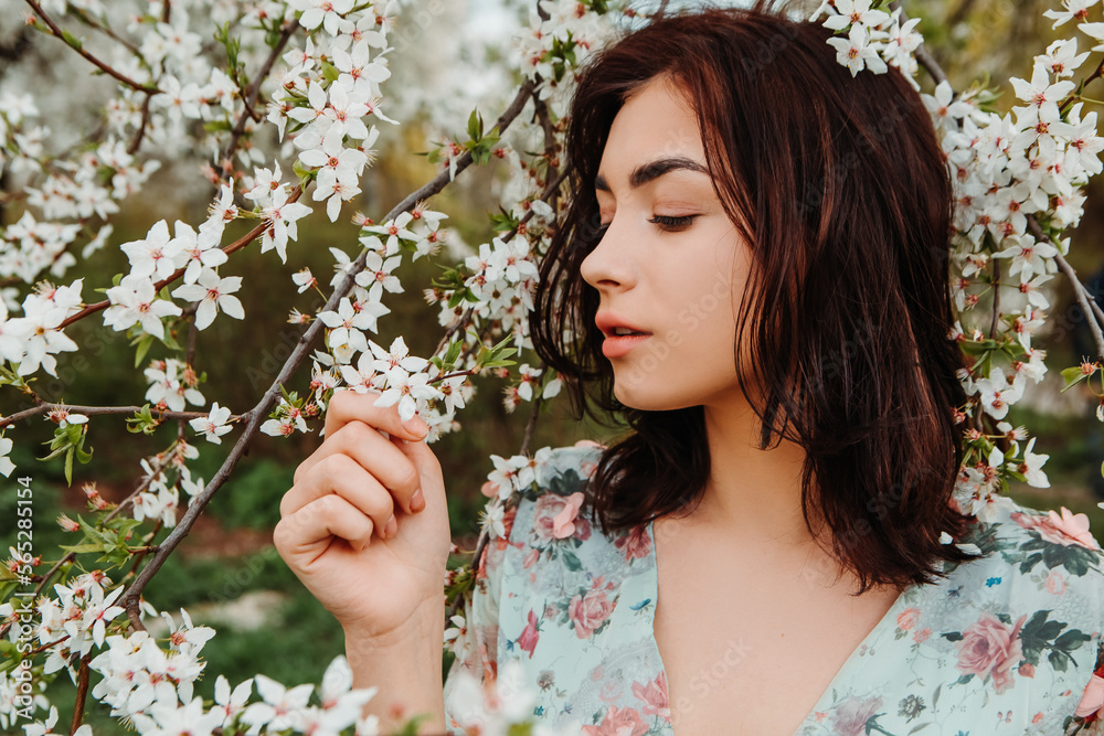 Profile pose looking to side woman dressed flowery dress posing near apple cherry tree blossoms blooming flowers in the garden park in early spring nature. Fashion, girl model with black hair
Profile pose looking to side woman dressed flowery dress posing near apple cherry tree blossoms blooming flowers in the garden park in early spring nature. Fashion, girl model with black hair