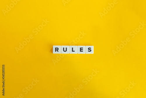 Rules Word on Block Letter Tiles on Yellow Background. Minimal Aesthetics.