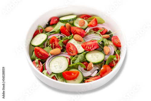 Isolated healthy salad with tomato, cucumber, greens and nuts, salad closeup 