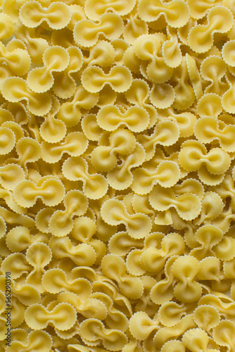 Top view of Farfalle tonde pasta shells on a table, dry uncooked Farfalle tonde