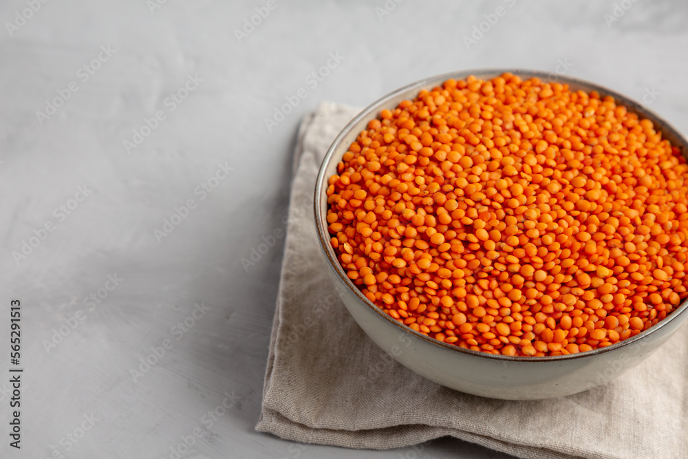 Red Lentils Legume in a Bowl on a gray background, side view. Copy space. Red Lentils Legume in a Bowl on a gray background, side view. Copy space.
