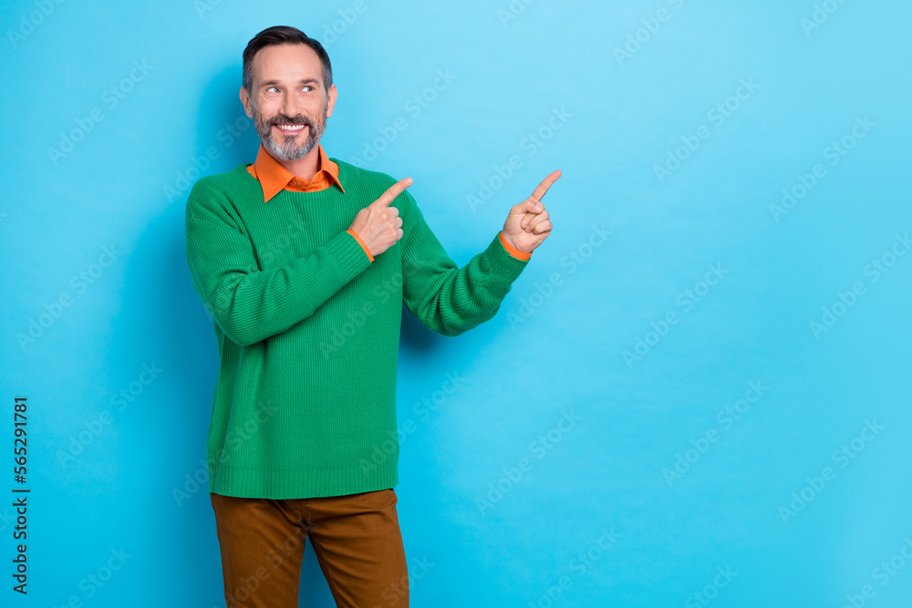 Photo of positive nice man beaming smile look interested empty space isolated on blue color background