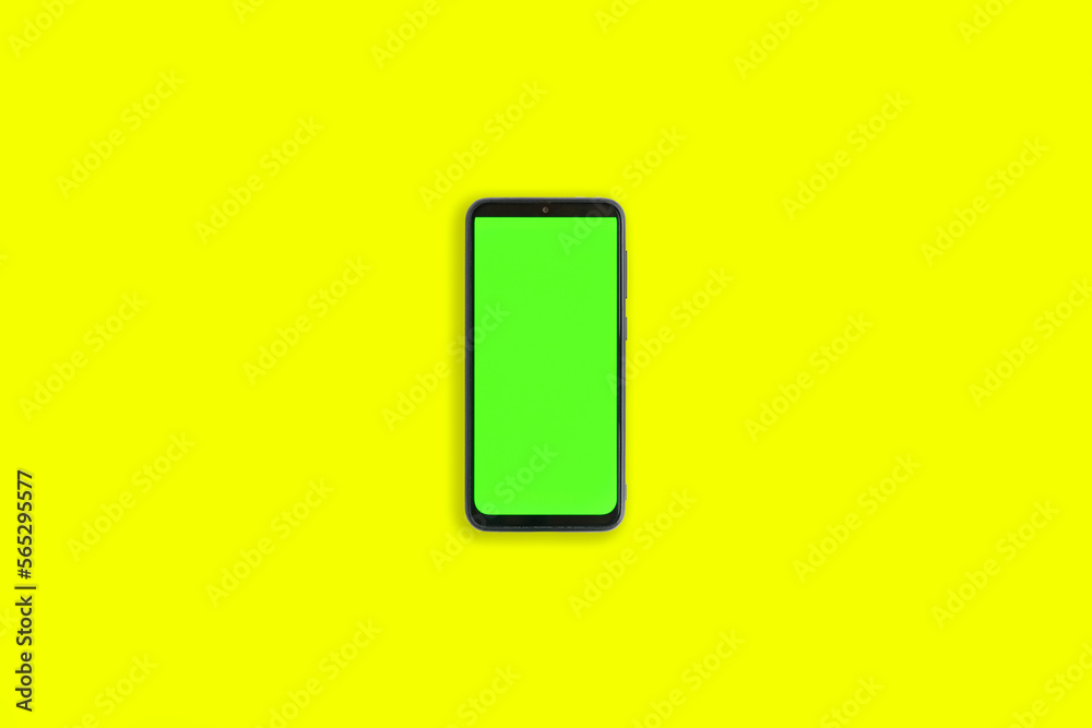 Phone with vertical green screen with chroma key isolated yellow background. Mock Up Display. Smartphone gadget for advertising. Top above view. Mobile phone with empty blank screen. Layout template Phone with vertical green screen with chroma key isolated yellow background. Mock Up Display. Smartphone gadget for advertising. Top above view. Mobile phone with empty blank screen. Layout template