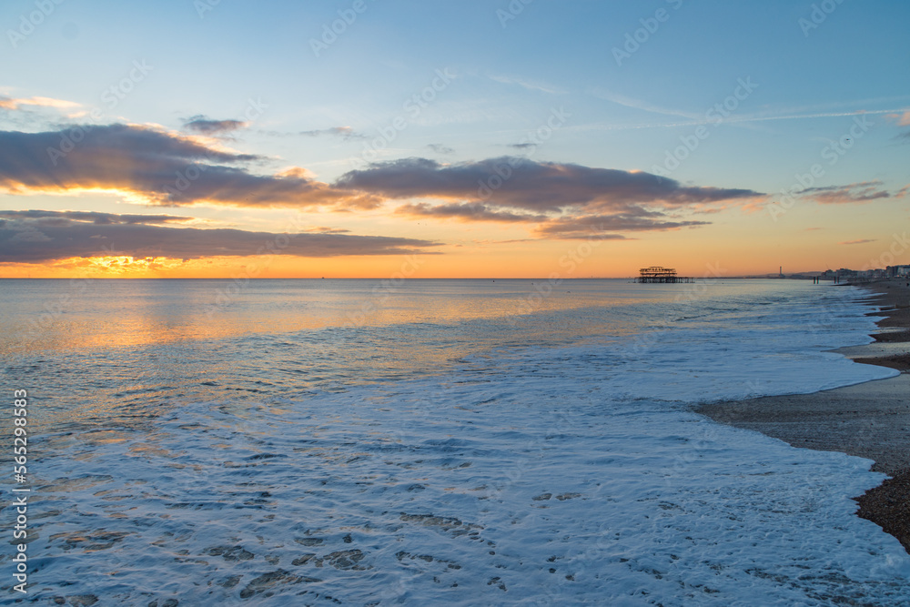 The sunsetting over the English Channel viewed from Brighton Beach, UK