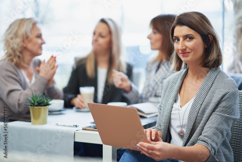 Picture of woman holding laptop on business meeting
