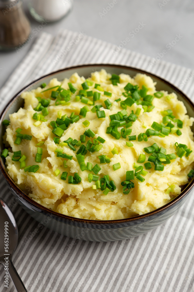 Homemade Mashed Potatoes with Chives in a Bowl, side view. Homemade Mashed Potatoes with Chives in a Bowl, side view.