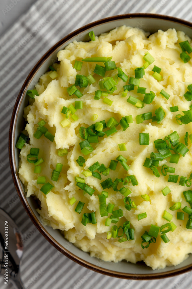 Homemade Mashed Potatoes with Chives in a Bowl, top view. Flat lay, overhead, from above. Homemade Mashed Potatoes with Chives in a Bowl, top view. Flat lay, overhead, from above.