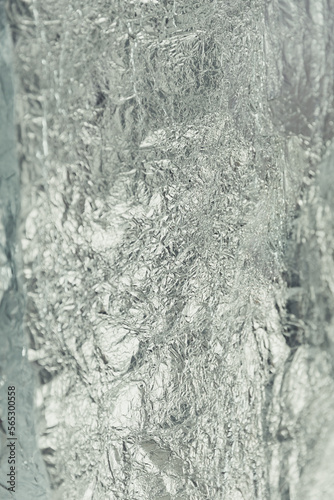 Defocused blurred silver foil as texture background and wrapping material