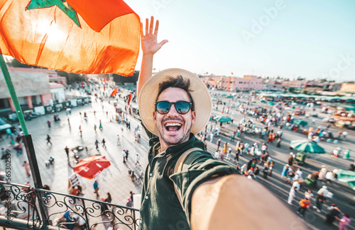 Happy tourist visiting Jamaa el-Fna market, Morocco - Handsome man taking selfie enjoying summer vacation outside - Holidays and travel blogger concept