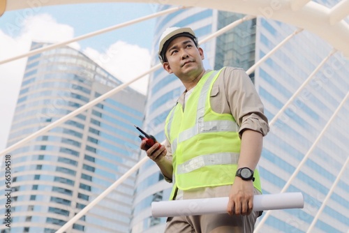 Wallpaper Mural 
Engineers using walkie-talkie in construction site. civil engineer walk around construction site outdoor. Torontodigital.ca