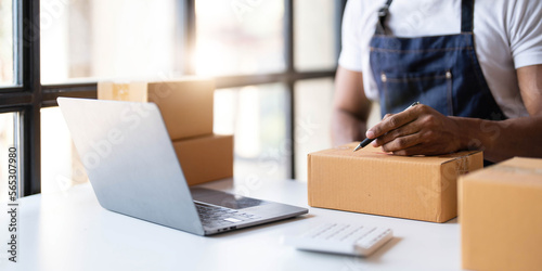 Starting small businesses SME owners male entrepreneurs Write the address on receipt box and check online orders to prepare to pack the boxes, sell to customers, sme business ideas online.