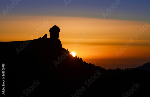 The sun going down over the Roque Nublo silhouette, Roque Nublo Rural Park, Gran Canary, Canary Islands, Spain