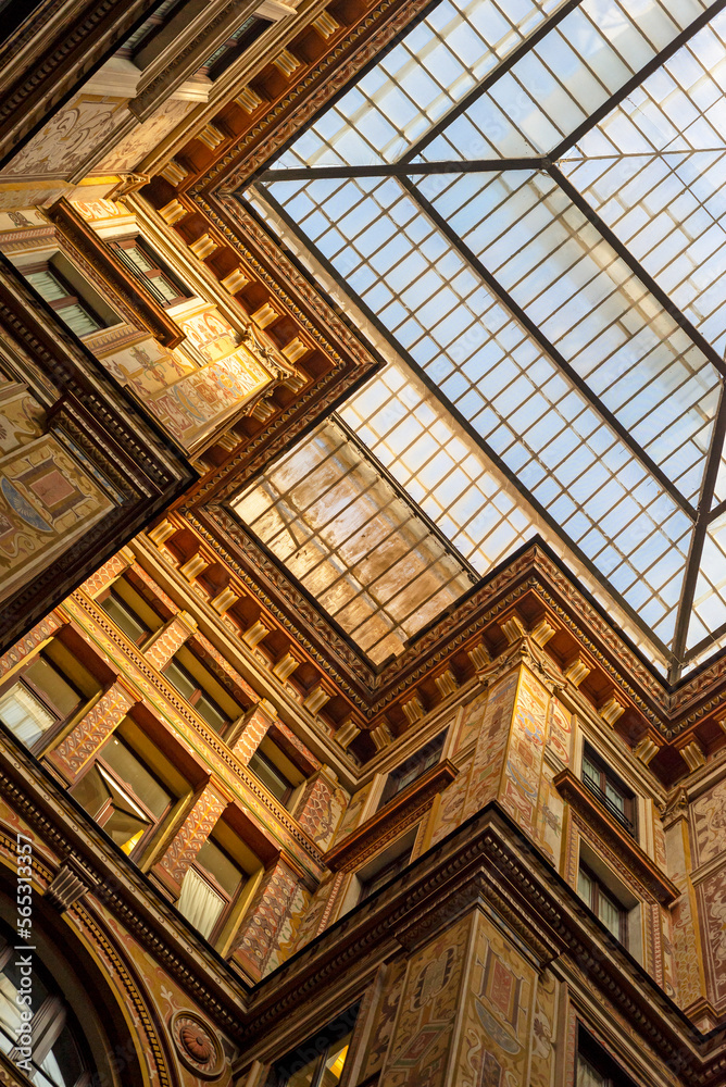 Part of a building and a glass roof in Rome. Windows, walls, facades, ornamentation.