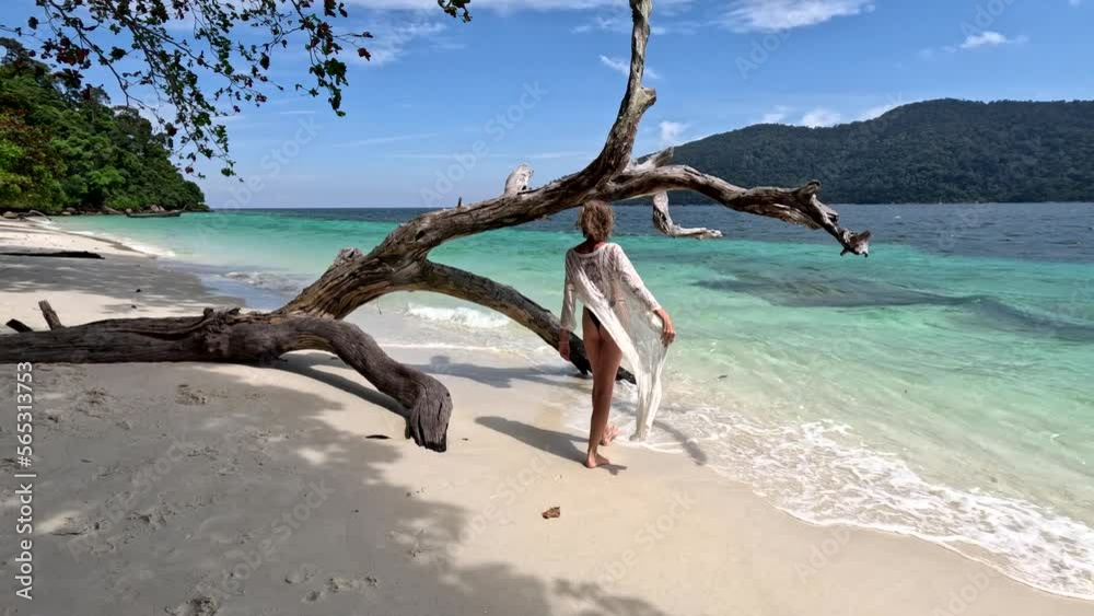 Calm, happy woman in black bikini and sunglasses relaxing on the tropical beach. Fit tanned body. Paradise island in Thailand, Asia. Travel. Tourism. Calm, happy woman in black bikini and sunglasses relaxing on the tropical beach. Fit tanned body. Paradise island in Thailand, Asia. Travel. Tourism.