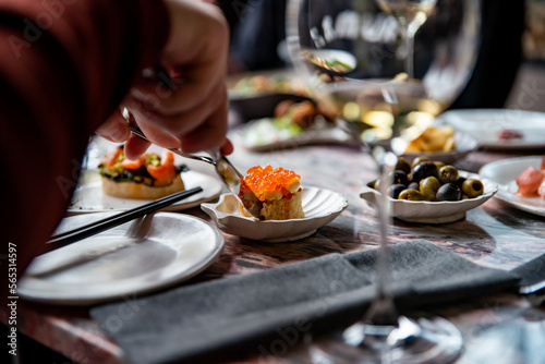 man eat Canape with brioche, butter, salmon red caviar.