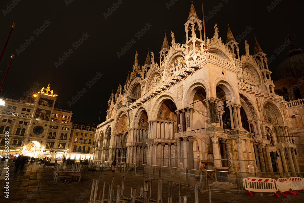 Saint Mark Cathedral in Venice and the bell tower with two bronze players on night view 