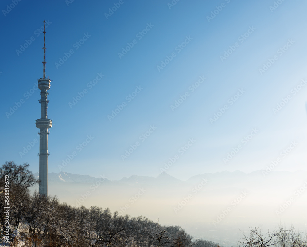 Almaty Television Tower and mountain view during winter smog.  Kazakhstan