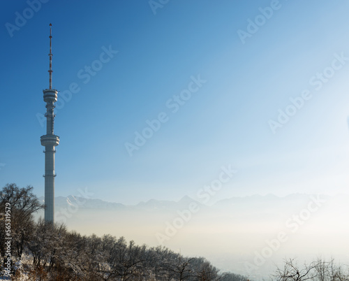 Almaty Television Tower and mountain view during winter smog.  Kazakhstan