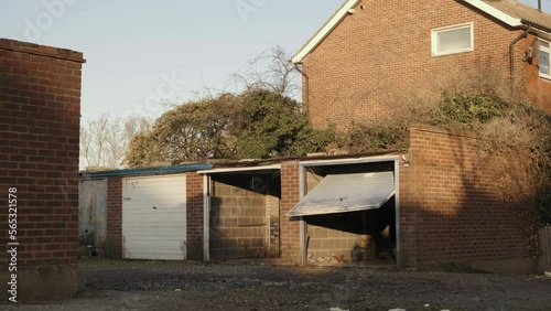Old abandoned car garages next to residential houses