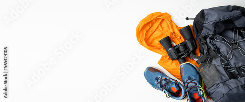 Binoculars, tourist things, shoes on a white background. Top view, flat lay. Banner