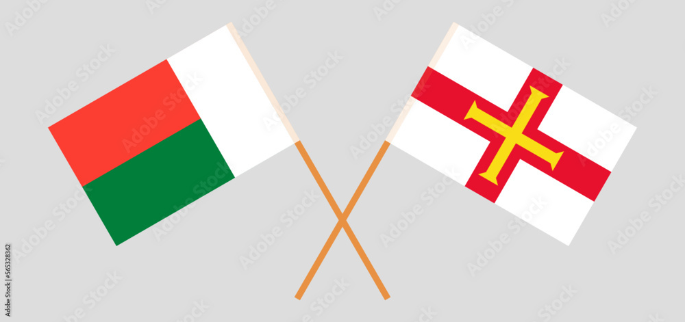 Crossed flags of Madagascar and Bailiwick of Guernsey. Official colors. Correct proportion