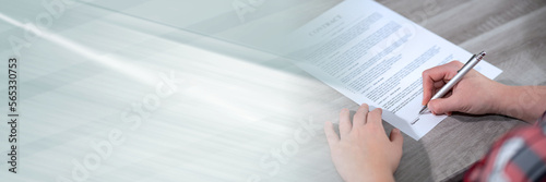 Woman hands signing a document; panoramic banner