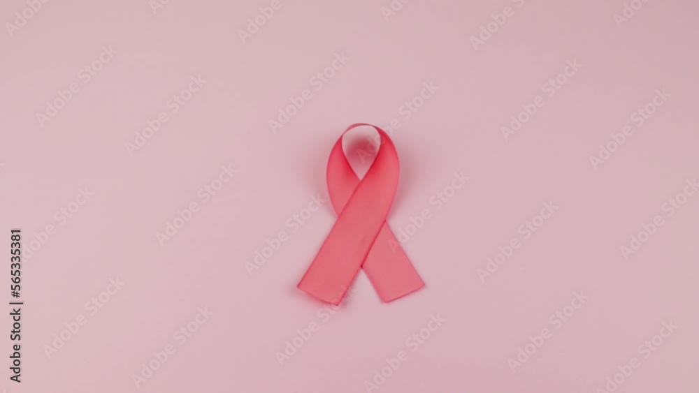Video of Hands placing a pink Ribbon as a symbol of Cancer Awareness Month (World Cancer Day) on a pink background, space to copy.
Video of Hands placing a pink Ribbon as a symbol of Cancer Awareness Month (World Cancer Day) on a pink background, space to copy.