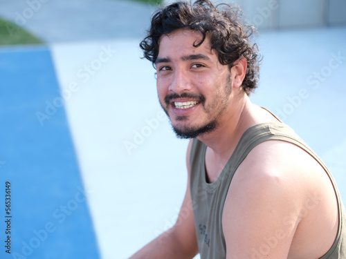 Nepalese man in a green singlet smiling