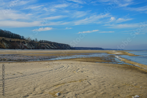 Natural background, sandy shore and water.