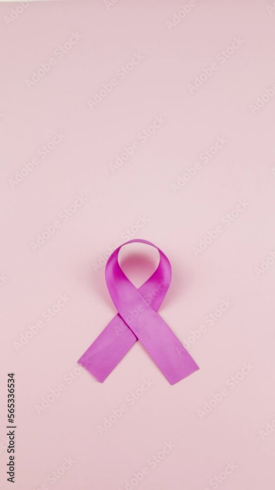 Video of Hands placing a pink Ribbon as a symbol of Cancer Awareness Month (World Cancer Day) on a pink background, space to copy.
Video of Hands placing a pink Ribbon as a symbol of Cancer Awareness Month (World Cancer Day) on a pink background, space to copy.