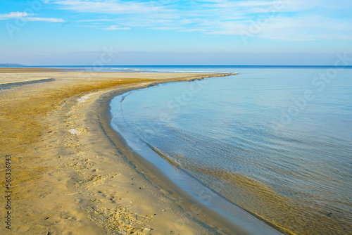 Natural background  sandy shore and water.