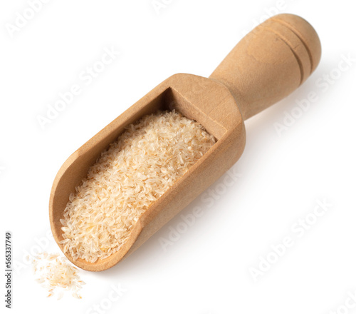 Psyllium husks in the wooden scoop, isolated on white background.