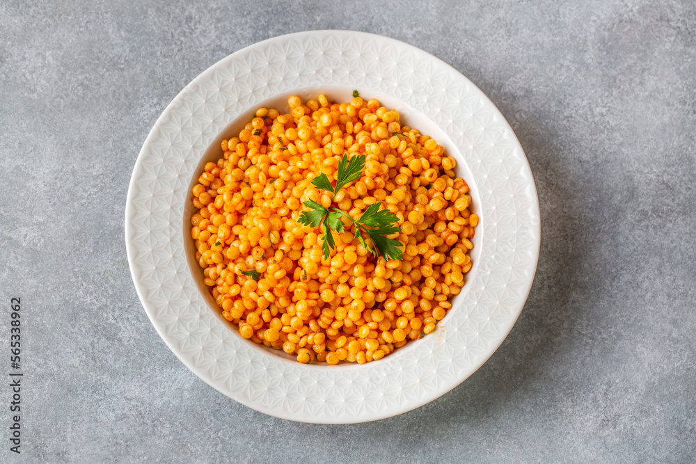 Couscous pilaf with tomatoes. Turkish name; domatesli kuskus pilavi Couscous pilaf with tomatoes. Turkish name; domatesli kuskus pilavi