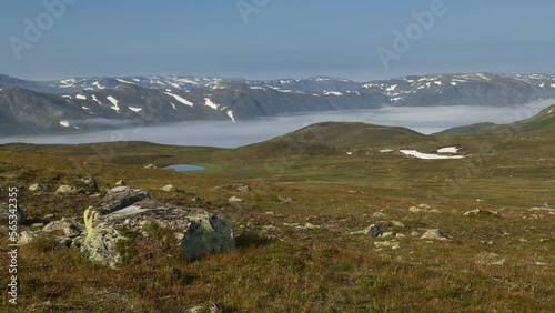 fog fills the valley of bygdin lake photo