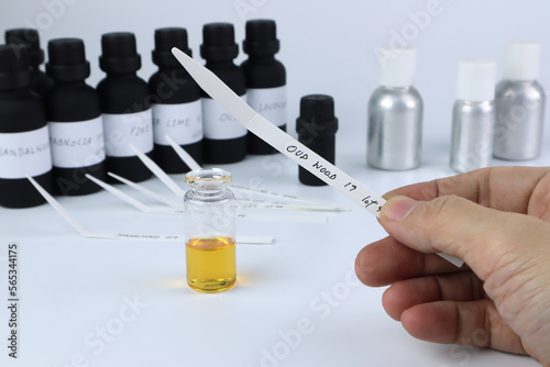 Fotografia blotter paper is in a right hand with background essential oil and fragrance oil