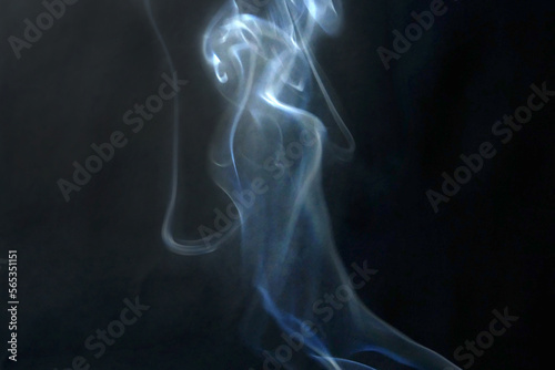 Scary white ghost on dark background from white smoke, ghost in fog
