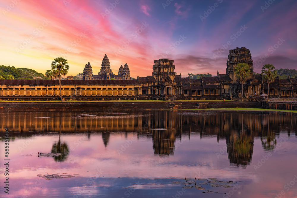 Angkor Wat temple reflecting in water of Lotus pond at sunset