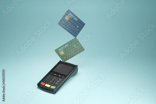 Card payment machine and credit cards on cyan background. Illustration of the concept of prepayment and debt photo