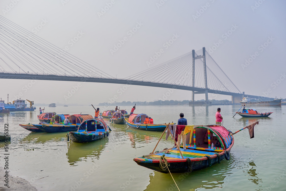 Colorful country boats used for tourist cruises on the Hooghly River in Calcutta, India
