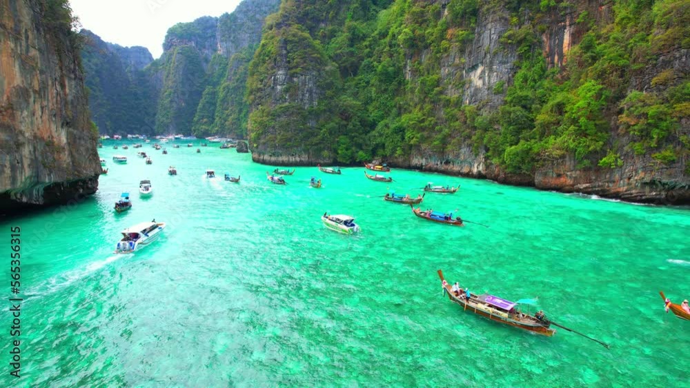 Aerial view over tropical sea, beautiful waters look more green than blue, limestone cliffs which have impressive vegetation. Long-tailed boats and many tourists. Pileh lagoon, Krabi, Thailand. 4K UHD Aerial view over tropical sea, beautiful waters look more green than blue, limestone cliffs which have impressive vegetation. Long-tailed boats and many tourists. Pileh lagoon, Krabi, Thailand. 4K UHD