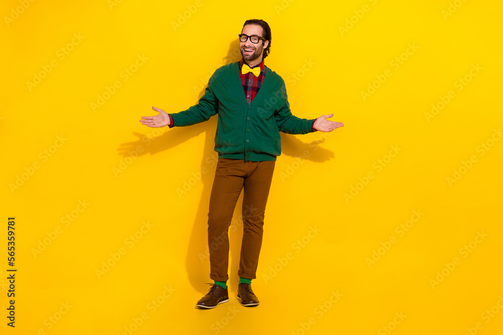 Full length portrait of friendly dandy neat person opened arms invite welcome isolated on yellow color background Full length portrait of friendly dandy neat person opened arms invite welcome isolated on yellow color background