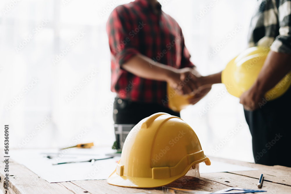 Close up handshake of two engineers. Group of industries workers meet on manufacture site shake hands. Close up handshake of two engineers. Group of industries workers meet on manufacture site shake hands.
