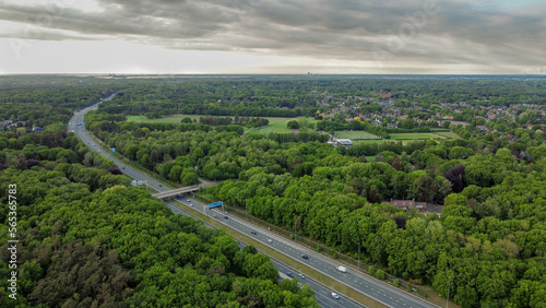 Arial view of a Dutch highway surrounded by trees, in early summer.