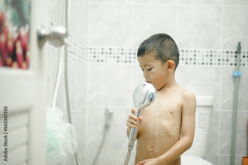Happy little boy washing head in shower in the bathroom,Happy boy