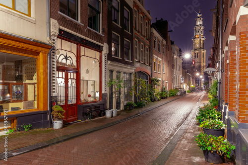 Night street in Amsterdam against the background of the Westerkerk tower.