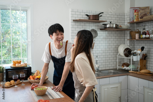 lovely Asian Couple Cooking Food Together.  preparing cooking food meal for romantic dinner, spending time together..